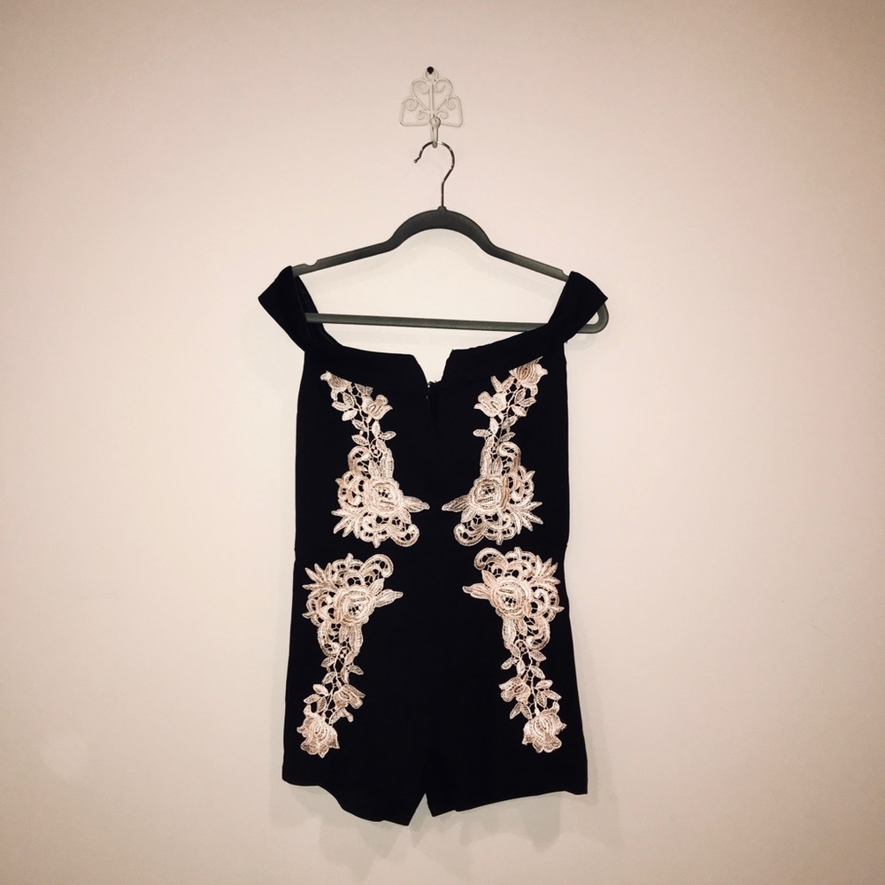 Black bodycon romper with gold detail lacing